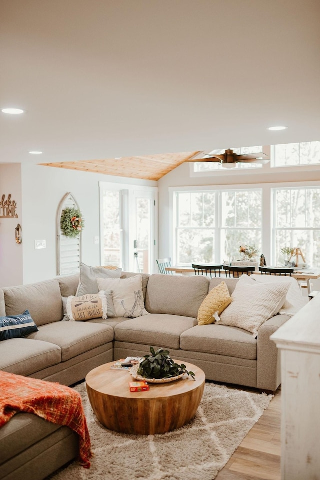 living room featuring light hardwood / wood-style flooring and ceiling fan