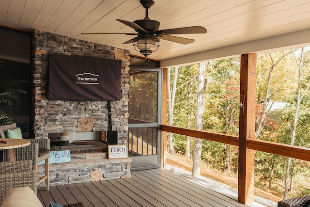 unfurnished sunroom featuring ceiling fan