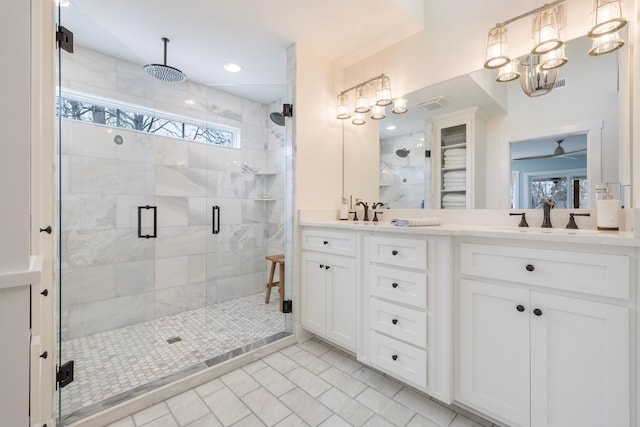 bathroom featuring vanity, a shower with door, tile patterned floors, and ceiling fan