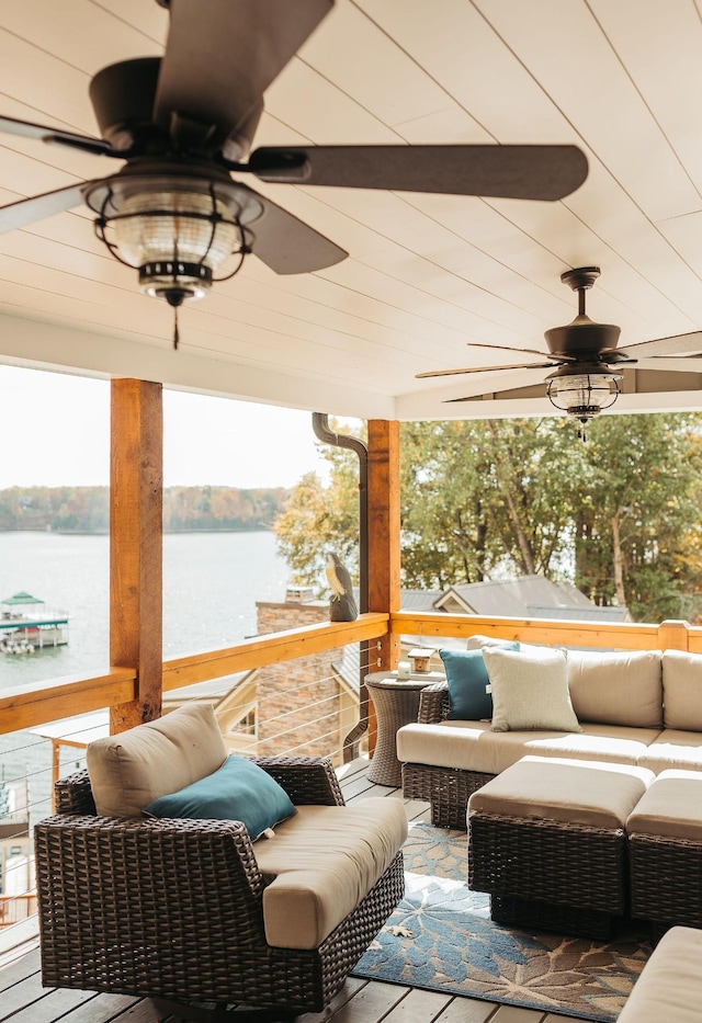 view of patio featuring ceiling fan, a water view, and an outdoor hangout area