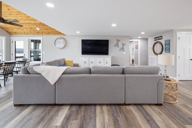 living area with a ceiling fan, recessed lighting, vaulted ceiling, and wood finished floors