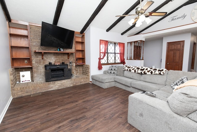 living room featuring vaulted ceiling with beams, ceiling fan, dark wood-type flooring, and a wood stove