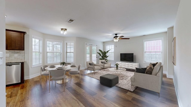 living room with ceiling fan and dark hardwood / wood-style flooring