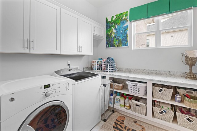 washroom featuring cabinets and washing machine and dryer