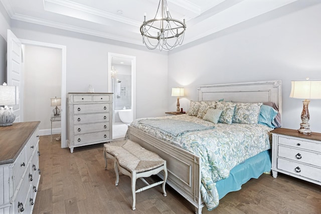 bedroom with connected bathroom, a chandelier, crown molding, and dark wood-type flooring