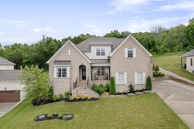 view of front of house with a front yard and covered porch