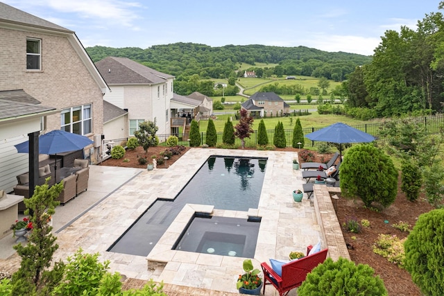 view of pool featuring an in ground hot tub and a patio