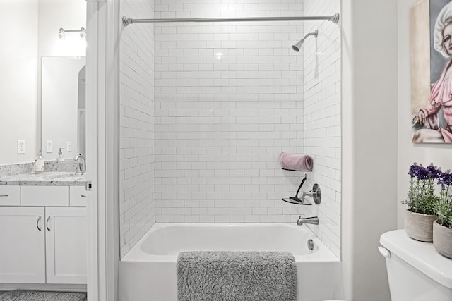 full bathroom featuring vanity, toilet, and tiled shower / bath