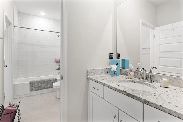 full bathroom featuring tile patterned floors, vanity, tiled shower / bath combo, and toilet