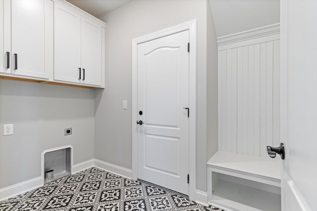 washroom with hookup for an electric dryer and cabinets