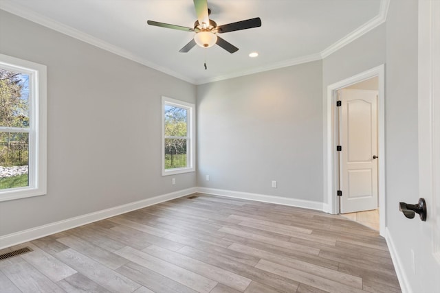 empty room featuring crown molding, ceiling fan, and light wood-type flooring