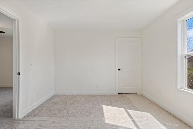 spare room featuring light colored carpet