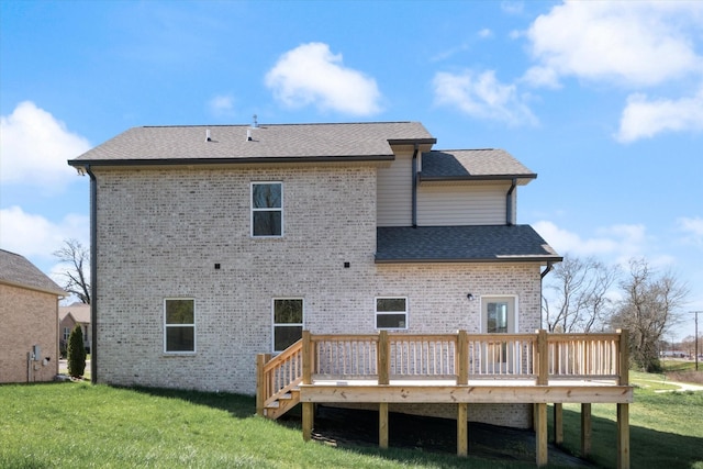 rear view of house featuring a lawn and a deck