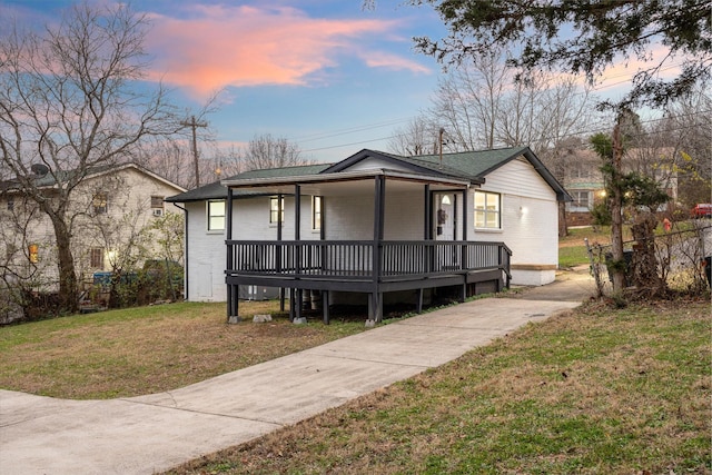 view of front of house featuring a yard and covered porch