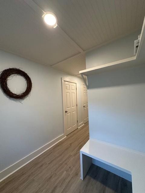 mudroom featuring dark wood-type flooring and baseboards