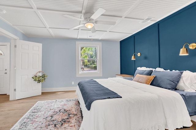 bedroom featuring ceiling fan, light wood-type flooring, coffered ceiling, and baseboards