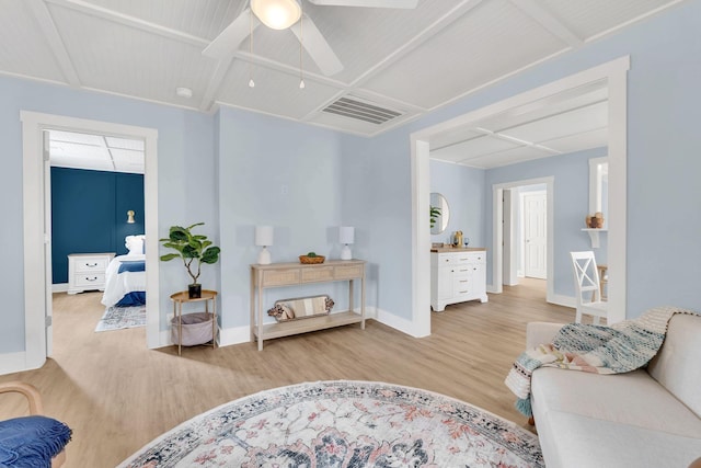 living area with light wood finished floors, visible vents, ceiling fan, beamed ceiling, and baseboards