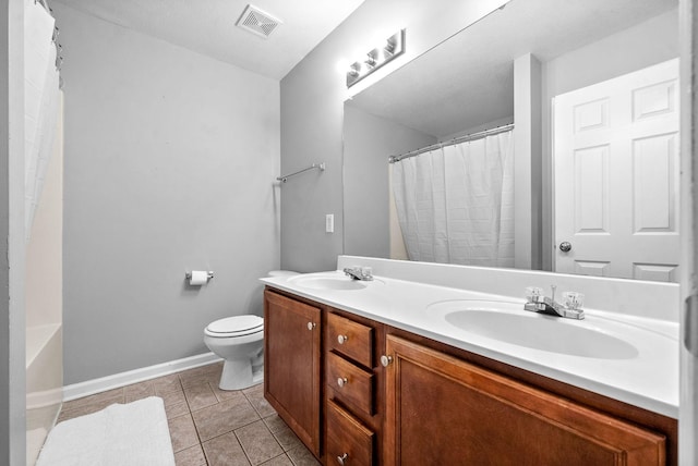 bathroom featuring tile patterned floors, vanity, and toilet