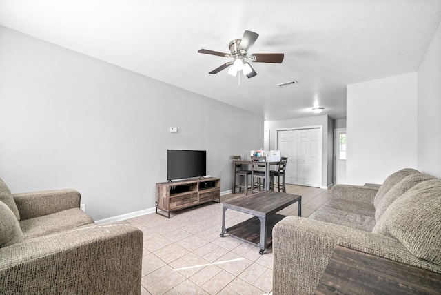 tiled living room featuring ceiling fan