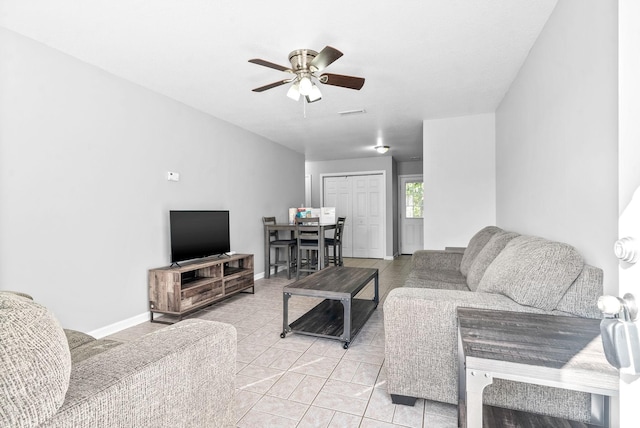 living room with ceiling fan and light tile patterned flooring