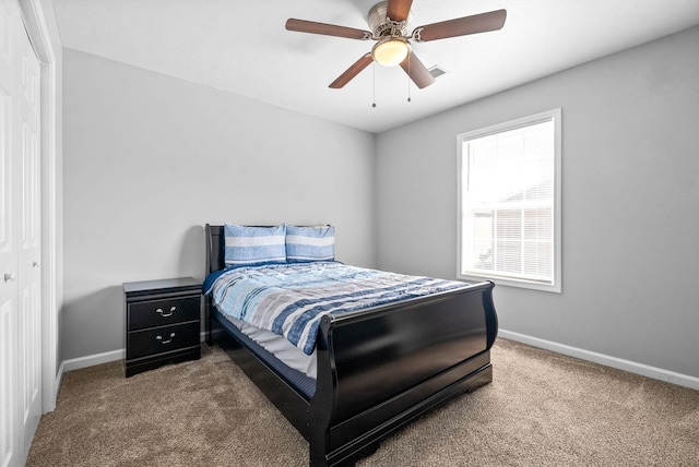 bedroom featuring ceiling fan, a closet, and carpet floors