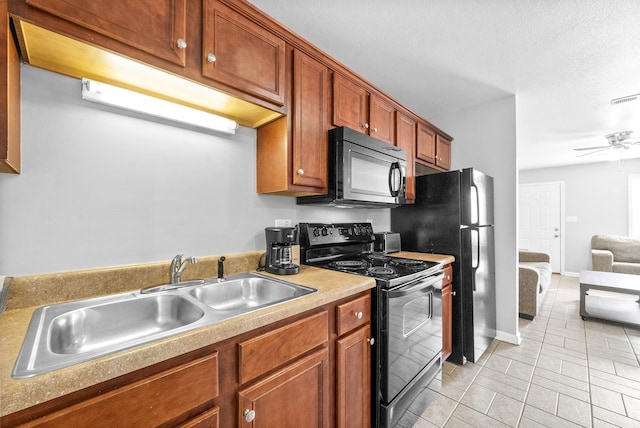 kitchen with ceiling fan, sink, light tile patterned flooring, and black appliances