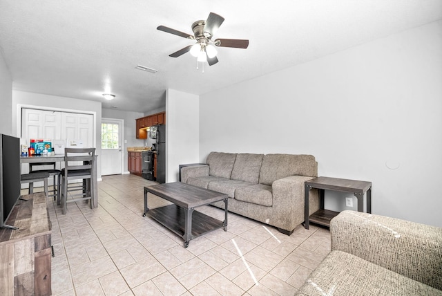 tiled living room featuring ceiling fan