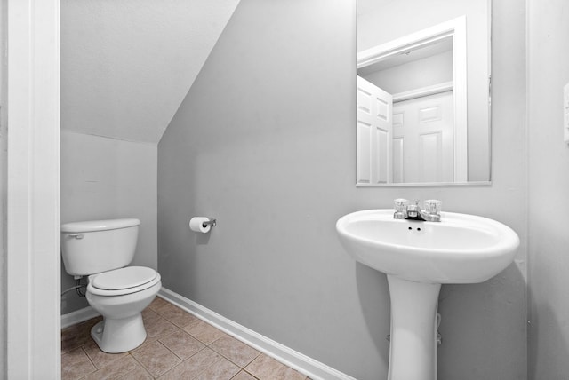 bathroom featuring tile patterned floors, toilet, and lofted ceiling
