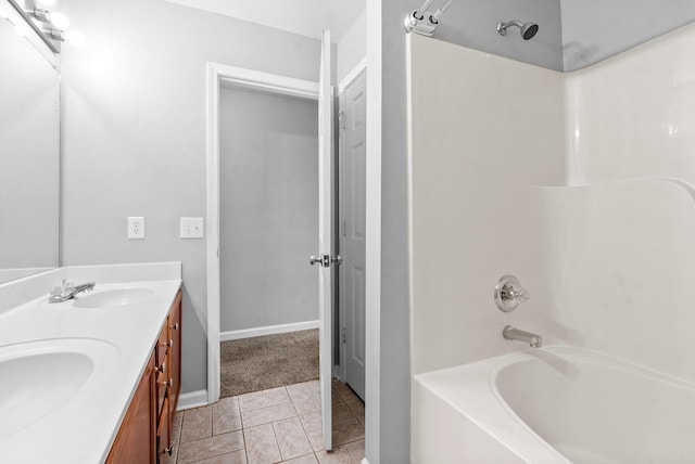 bathroom with tile patterned floors, shower / washtub combination, and vanity