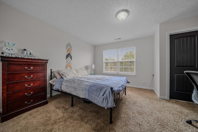 carpeted bedroom featuring a textured ceiling