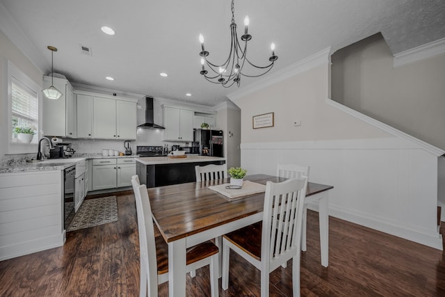 dining area featuring a chandelier, dark hardwood / wood-style floors, ornamental molding, and sink