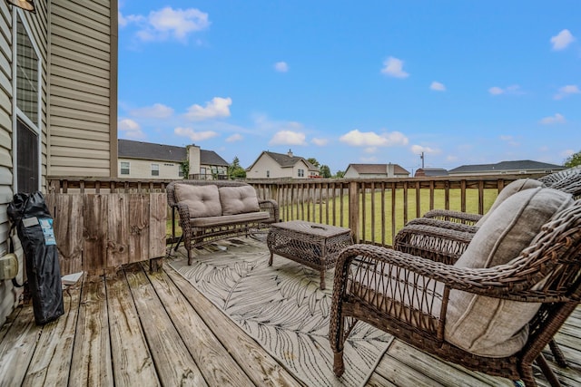 wooden terrace featuring a lawn