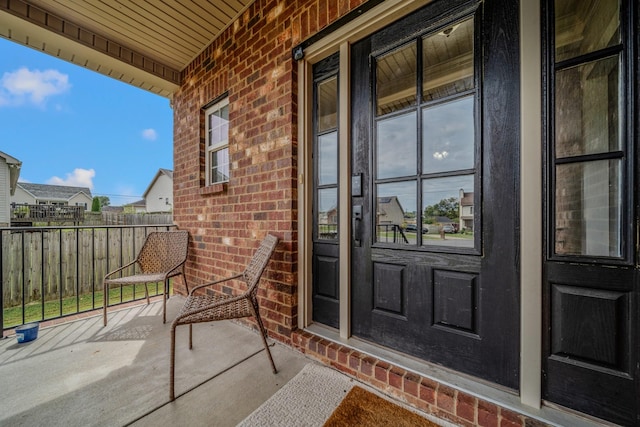 view of exterior entry with a porch