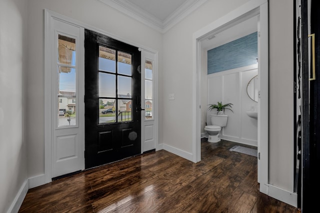 foyer featuring ornamental molding and dark wood-type flooring