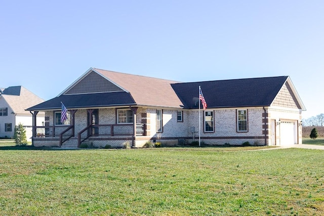 view of front of house with covered porch, a front yard, and a garage