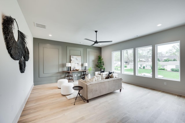 living room with ceiling fan and light hardwood / wood-style floors