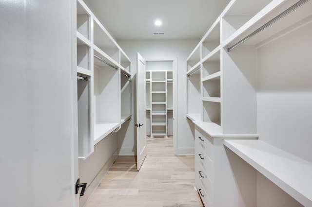 spacious closet featuring light hardwood / wood-style floors