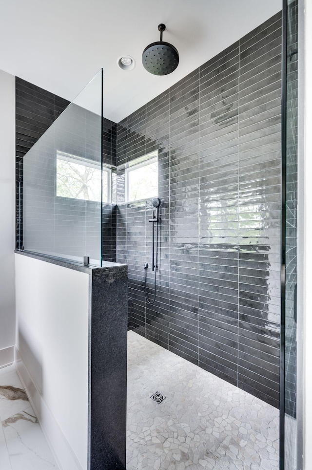 bathroom with a tile shower