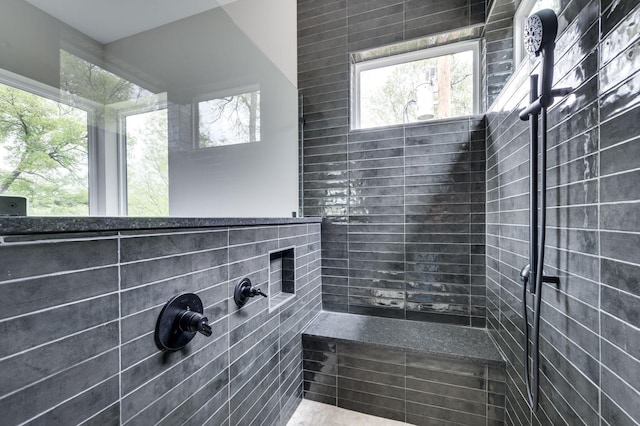 bathroom featuring tiled shower and a healthy amount of sunlight