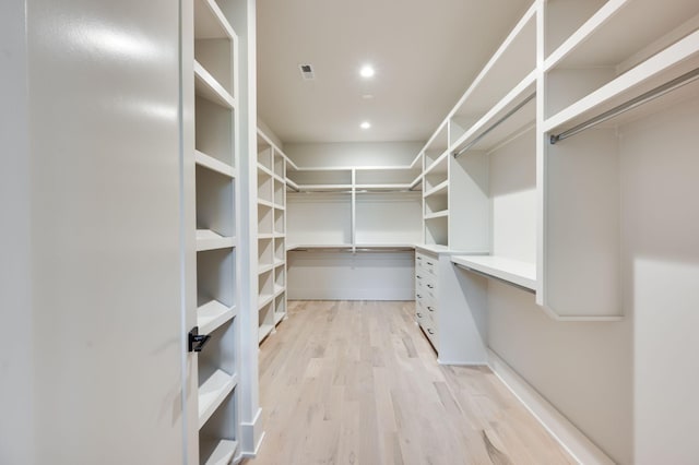 spacious closet with light hardwood / wood-style floors