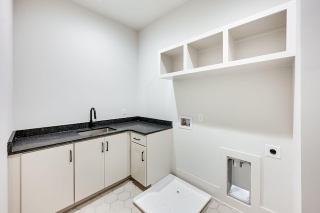 washroom with sink, cabinets, washer hookup, electric dryer hookup, and light tile patterned floors