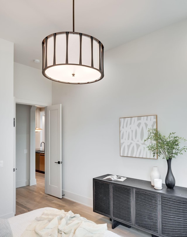 bedroom with light hardwood / wood-style flooring and sink