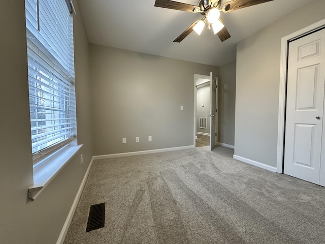 unfurnished bedroom with ceiling fan and carpet floors