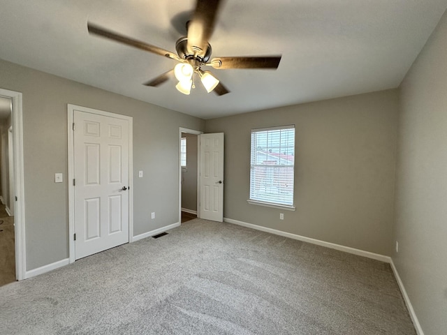 unfurnished bedroom with carpet floors and ceiling fan