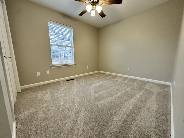 empty room featuring ceiling fan and carpet floors