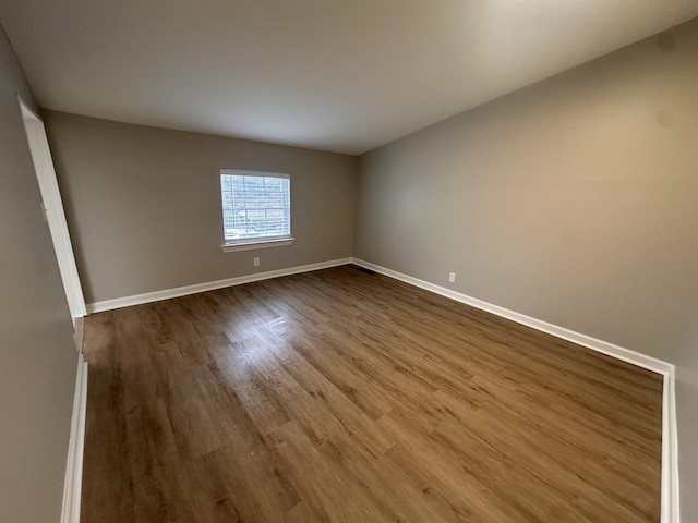 spare room with wood-type flooring