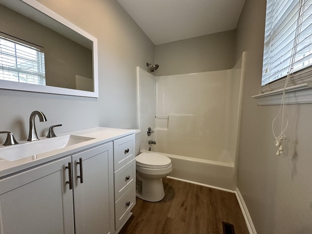 full bathroom with hardwood / wood-style floors, vanity, toilet, and bathing tub / shower combination