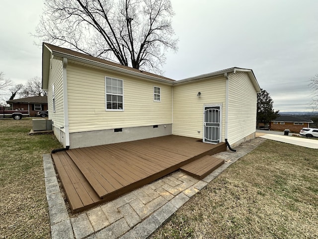 rear view of property featuring a lawn and a wooden deck