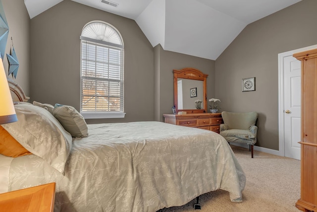 bedroom with carpet floors and vaulted ceiling