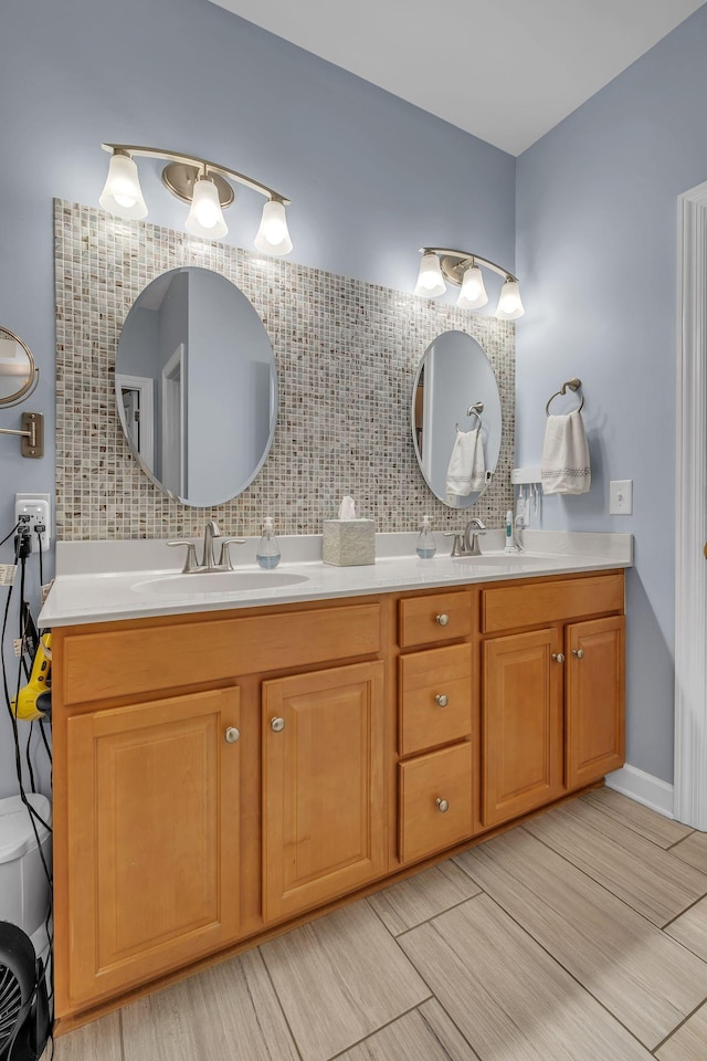 bathroom featuring vanity and backsplash